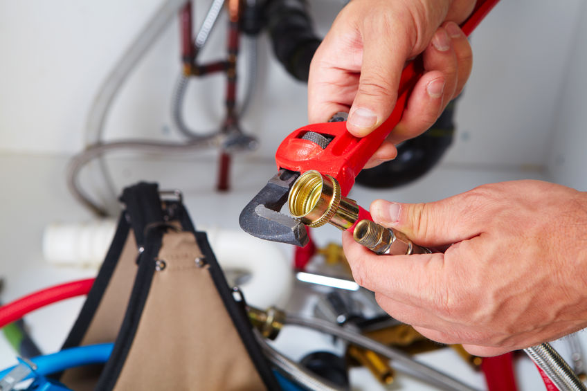 Plumber using a wrench